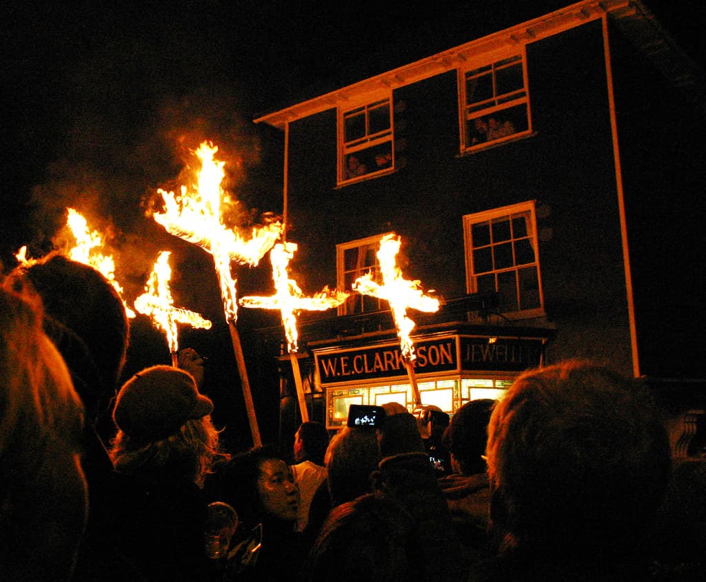Burning crosses carried above the crowd on a Lewes street on Bonfire Night